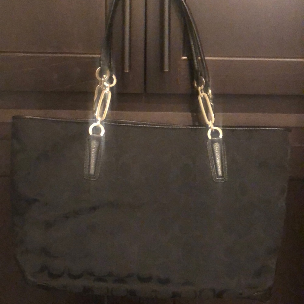 Black Coach purse with logo and leather trim.